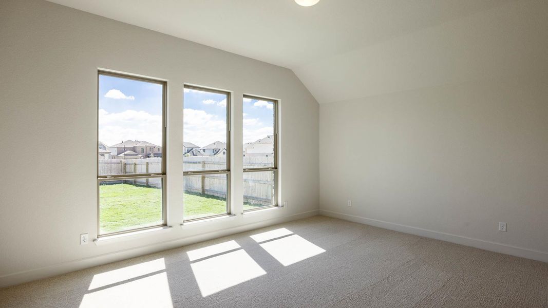 Additional living space featuring light carpet, a residential view, and lofted ceiling Additional living space featuring light carpet, a residential view, and lofted ceiling