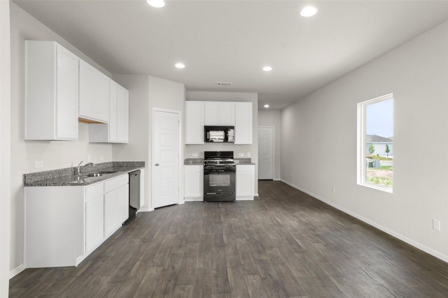 Kitchen featuring black appliances, dark wood-style flooring, white cabinets, and recessed lighting Kitchen featuring black appliances, dark wood-style flooring, white cabinets, and recessed lighting