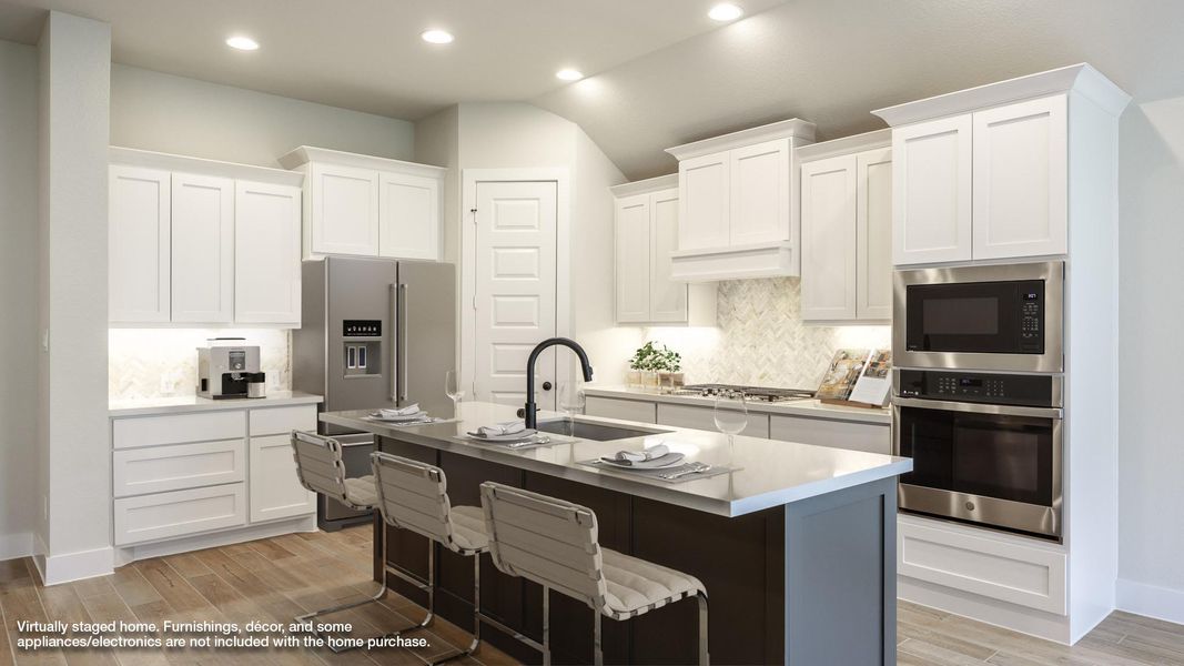 Kitchen with stainless steel appliances, a sink, backsplash, recessed lighting, and light wood finished floors Kitchen with stainless steel appliances, a sink, backsplash, recessed lighting, and light wood finished floors
