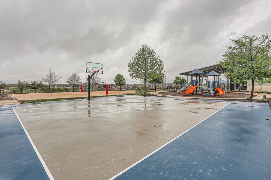 View of basketball court with community basketball court, fence, and playground community