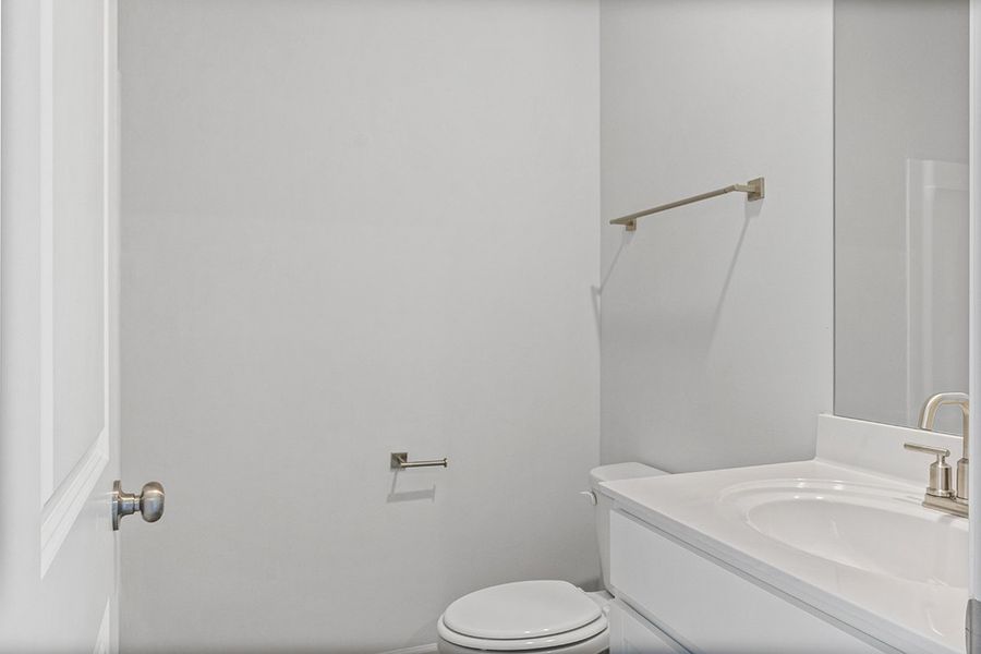 A bathroom with a toilet and sink. A bathroom with a toilet and sink.