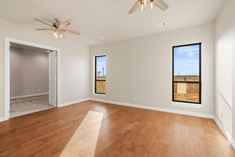 Unfurnished room featuring ceiling fan and light wood-type flooring