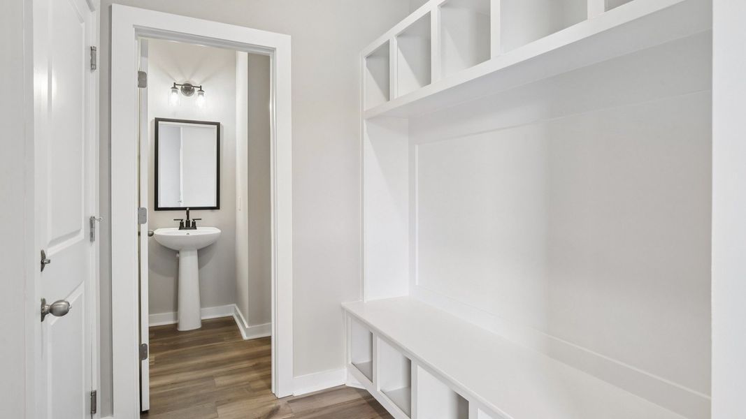 Powder room and built-in drop zone near front entry Powder room and built-in drop zone near front entry