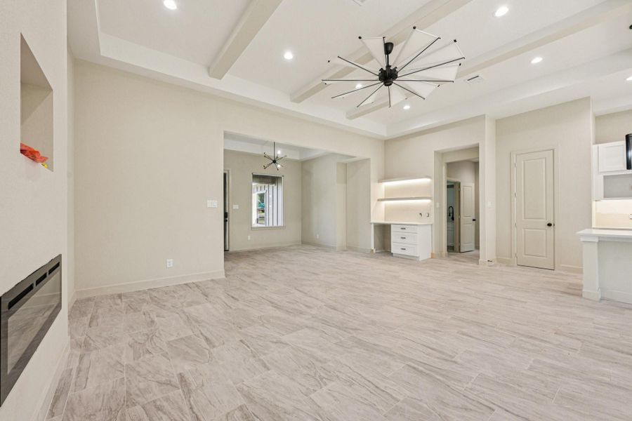 s living area features modern tile flooring, recessed lighting, and a contemporary Another view of the living area showing the coffee space, ceiling fan. and great open layout.