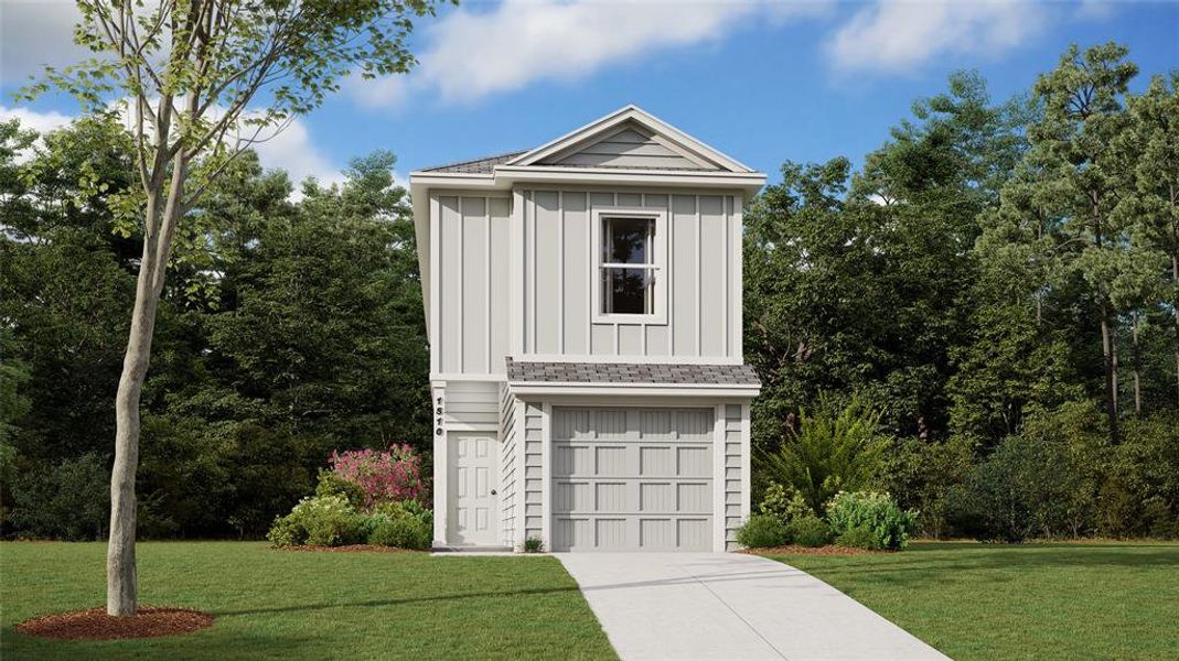 View of front of property featuring a front lawn and a garage