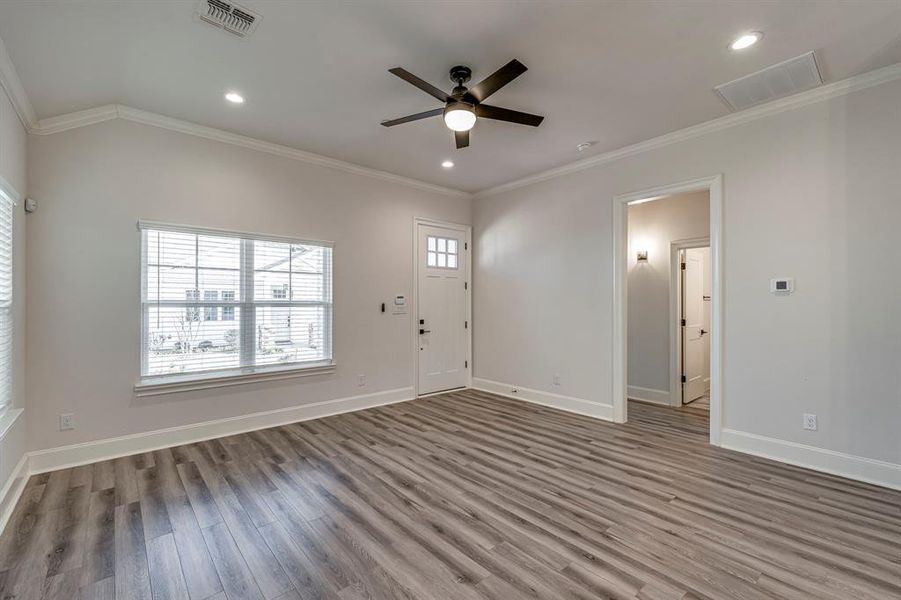 Unfurnished living room featuring crown molding, wood finished floors, recessed lighting, and ceiling fan Unfurnished living room featuring crown molding, wood finished floors, recessed lighting, and ceiling fan