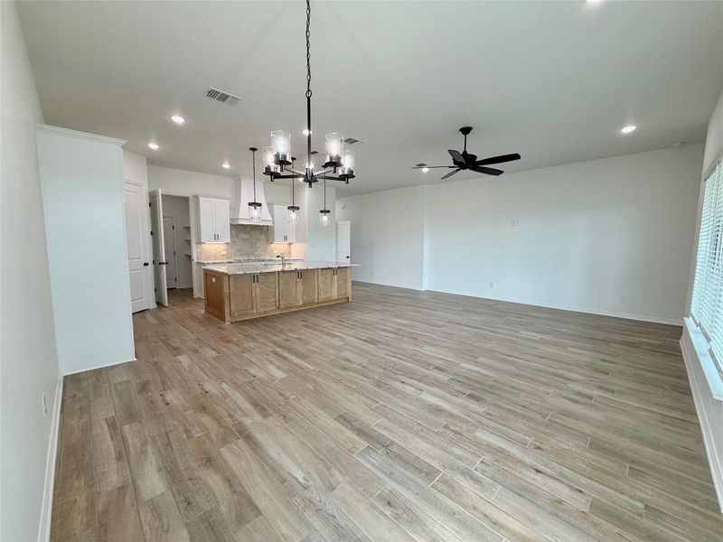 Expansive open concept living area featuring wood-finish flooring