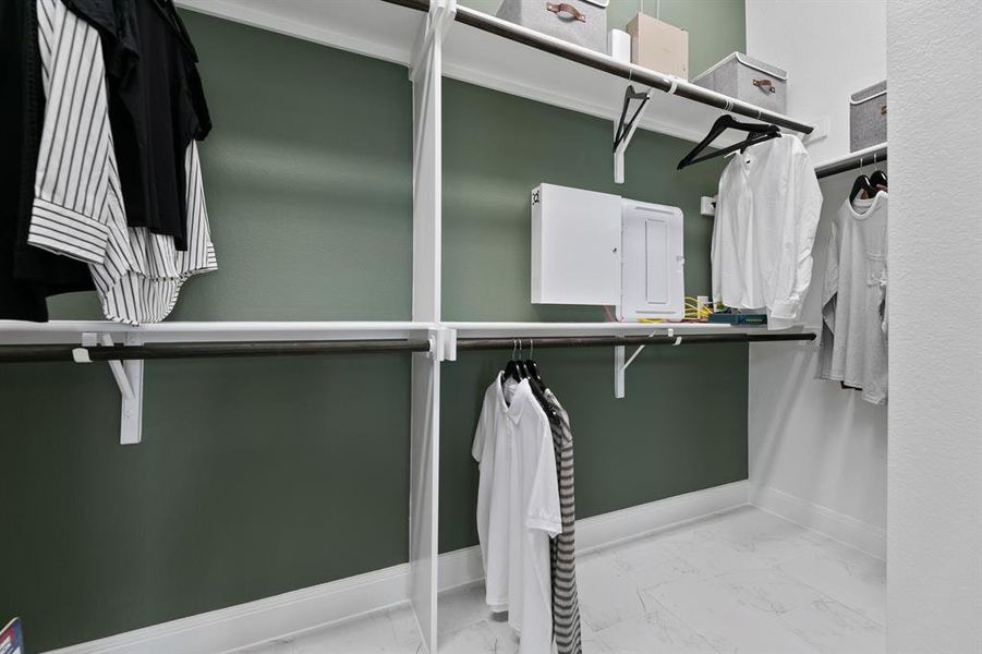 Walk in closet with light marble finish flooring Walk in closet with light marble finish flooring
