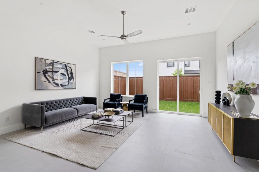 Spacious and inviting, the family room features soaring 11’ ceilings and seamless access to the backyard through sliding doors. Spacious and inviting, the family room features soaring 11’ ceilings and seamless access to the backyard through sliding doors.