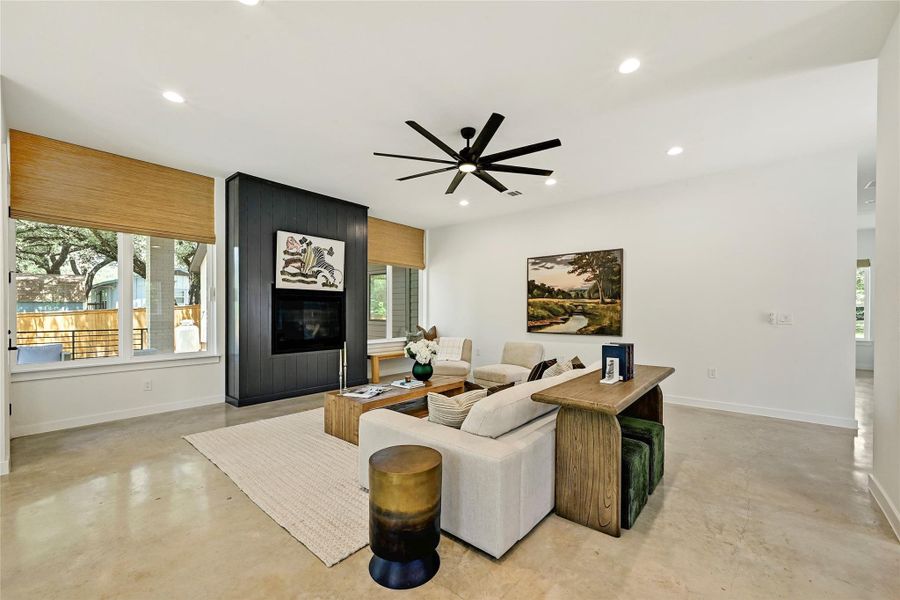 Polished concrete floors, custom cabinetry flanking fireplace, and seamless flow to kitchen and deck. Polished concrete floors, custom cabinetry flanking fireplace, and seamless flow to kitchen and deck.