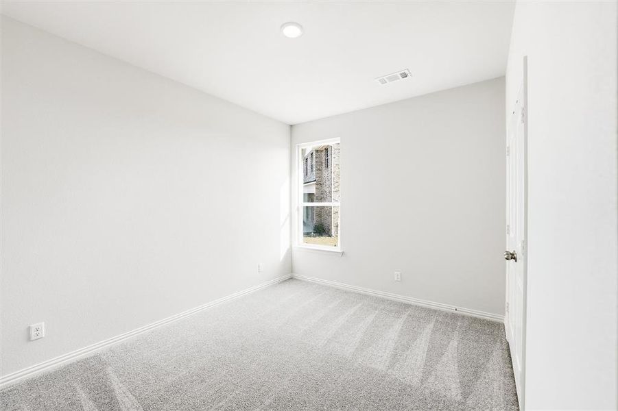 Spare room featuring carpet and baseboards