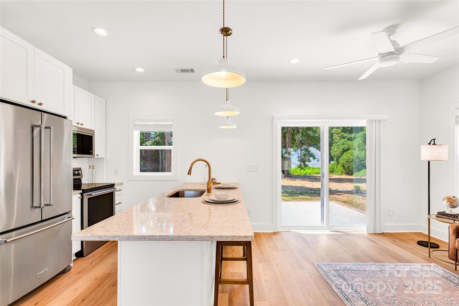 Open floor plan with large island and large sliding glass doors