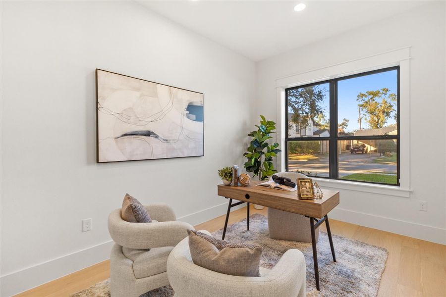 This is where your everyday meals turn into slow, meaningful moments. Your dining room is anchored by a solid wood table beneath a soft, statement chandelier that sets the mood without overpowering the space. Large windows frame leafy neighborhood views, filling the room with natural light while keeping things calm, bright, and inviting for dinners, celebrations, or quiet mornings with coffee.