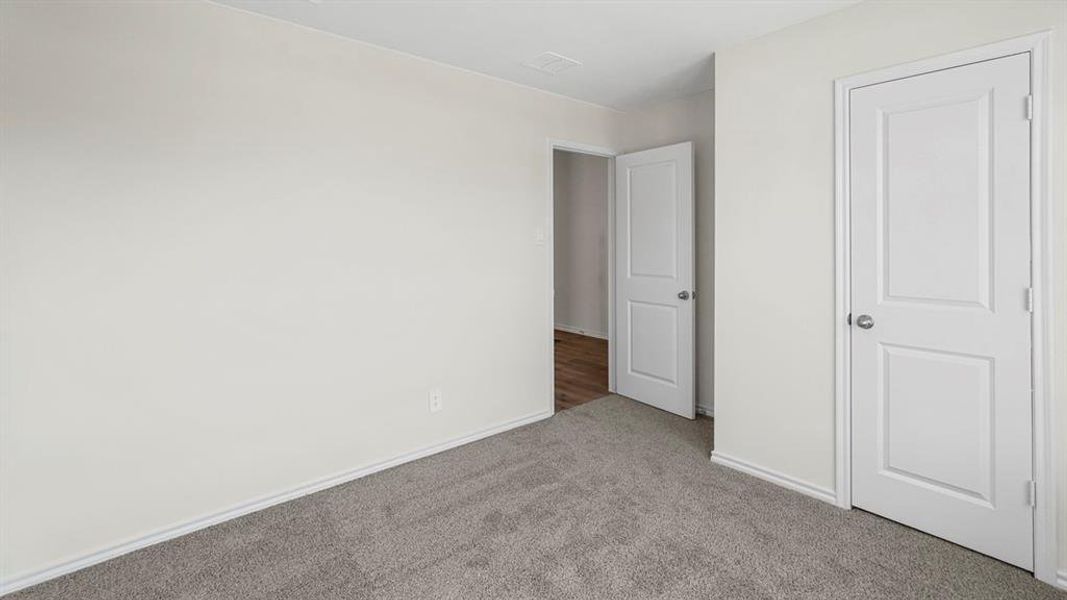 Unfurnished bedroom featuring carpet floors and baseboards