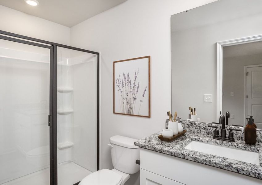 This bathroom has a glass-enclosed shower