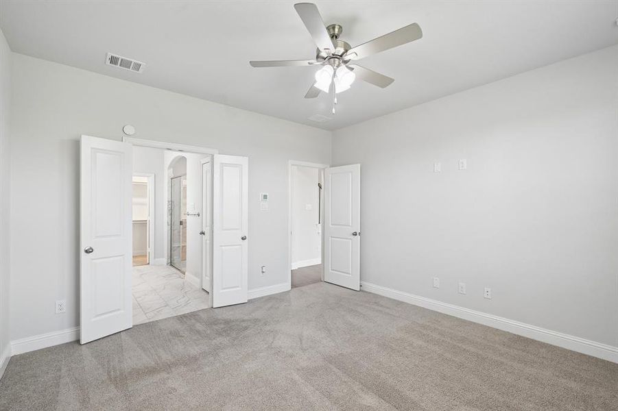 Spacious room featuring neutral carpeting and light gray walls Spacious room featuring neutral carpeting and light gray walls