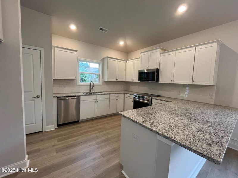 Furnished interior in a model home at Palmetto Creek in Bolivia (Image 6).