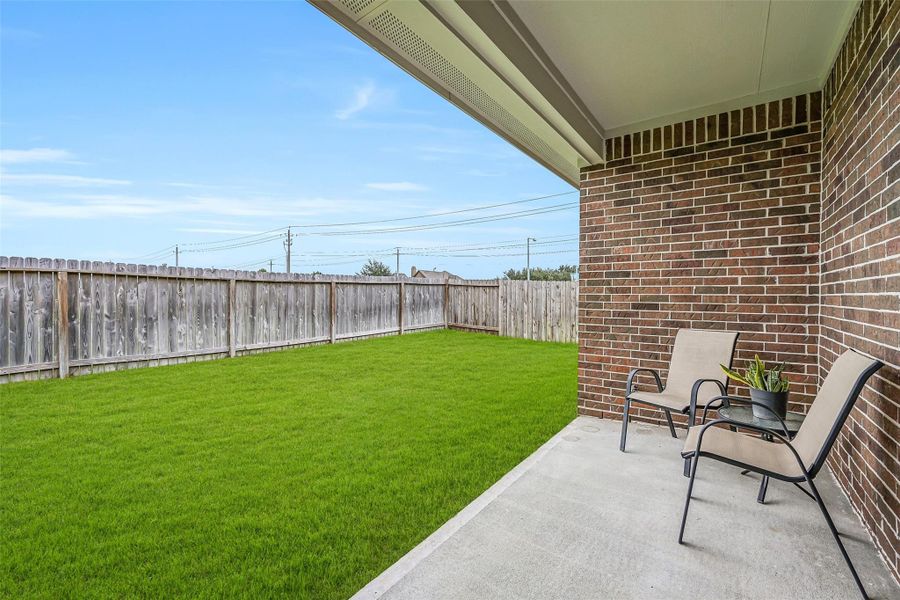 Step outside to the covered rear patio overlooking the spacious fenced backyard, offering a shaded spot for outdoor dining, morning coffee or simply relaxing while enjoying the green space beyond. Step outside to the covered rear patio overlooking the spacious fenced backyard, offering a shaded spot for outdoor dining, morning coffee or simply relaxing while enjoying the green space beyond.