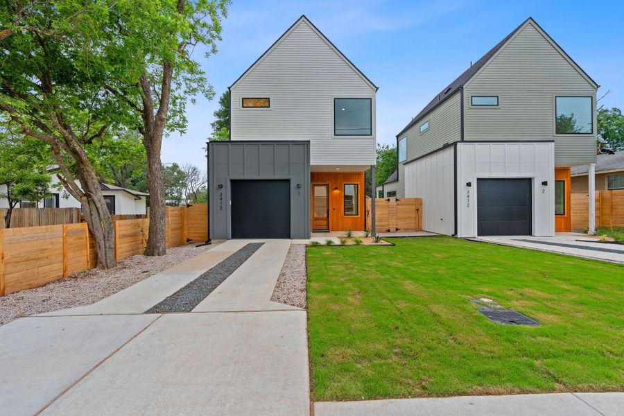 Modern home with board and batten siding, concrete driveway, and a garage Modern home with board and batten siding, concrete driveway, and a garage