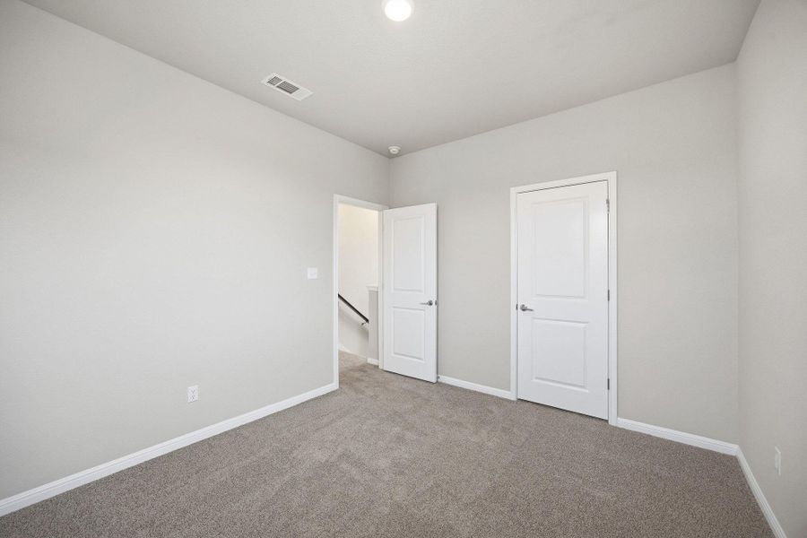 Unfurnished bedroom featuring baseboards and carpet flooring