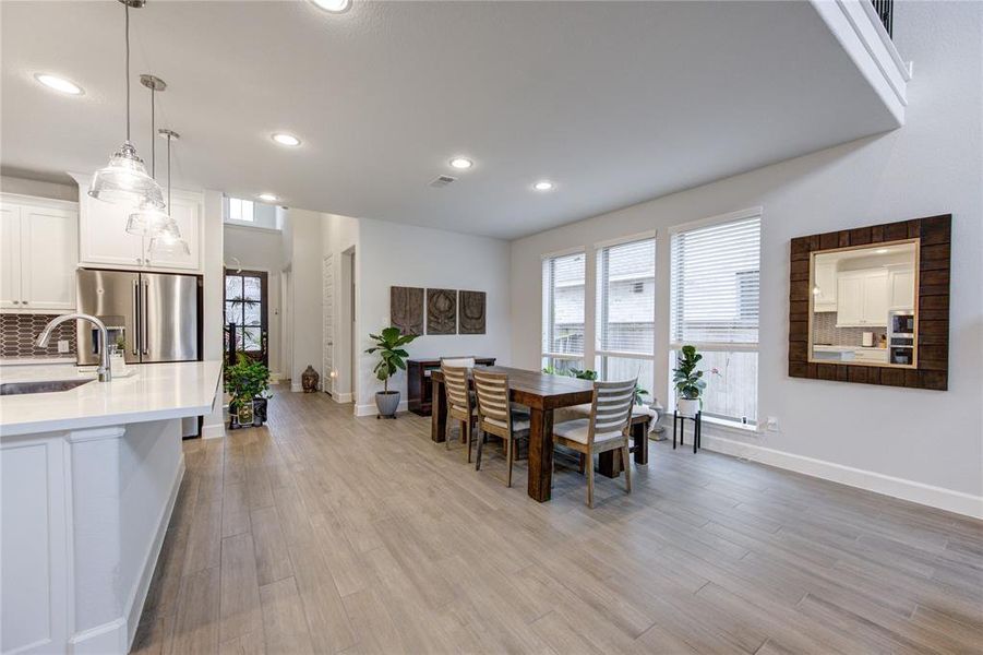 Check out the neutral wood-like title flooring throught the home.