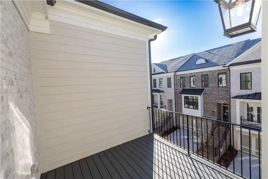 Primary bedroom private deck off sunroom/sitting area * Image is of a previously built home* Primary bedroom private deck off sunroom/sitting area * Image is of a previously built home*