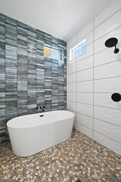 Full bath featuring tile walls and a freestanding bath