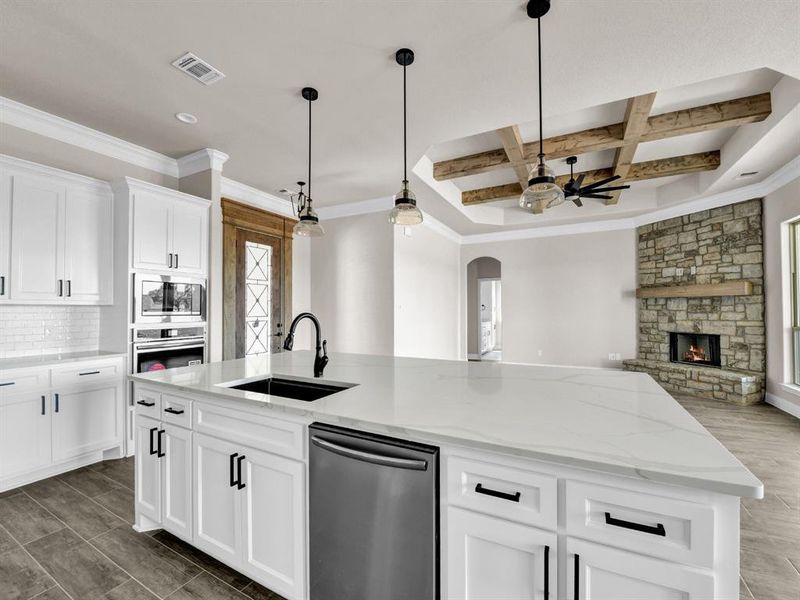 Kitchen featuring visible vents, appliances with stainless steel finishes, a sink, open floor plan, and coffered ceiling Kitchen featuring visible vents, appliances with stainless steel finishes, a sink, open floor plan, and coffered ceiling