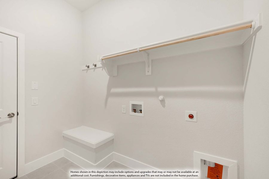 Laundry room with white walls, upper shelf, hanging rod, wall hookss, and washer and dryer hookups Laundry room with white walls, upper shelf, hanging rod, wall hookss, and washer and dryer hookups