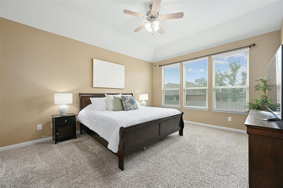 Primary bedroom with beautiful view of backyard.