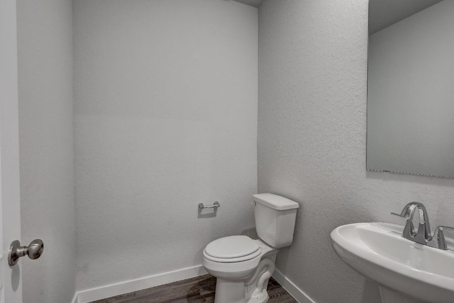 A bathroom with a toilet and sink.