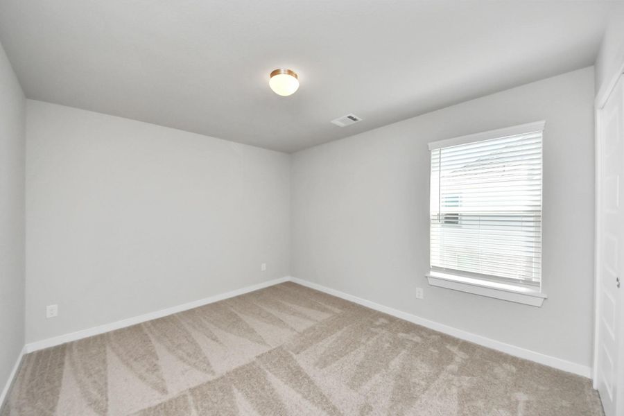 Secondary bedroom features plush carpeting, large windows that let in plenty of natural light, bright paint, and spacious closets. Secondary bedroom features plush carpeting, large windows that let in plenty of natural light, bright paint, and spacious closets.