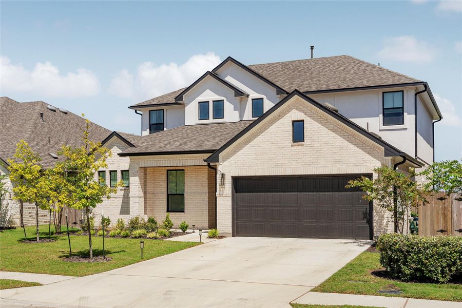 A striking modern facade with light brick and dark trim offers exceptional curb appeal. A striking modern facade with light brick and dark trim offers exceptional curb appeal.
