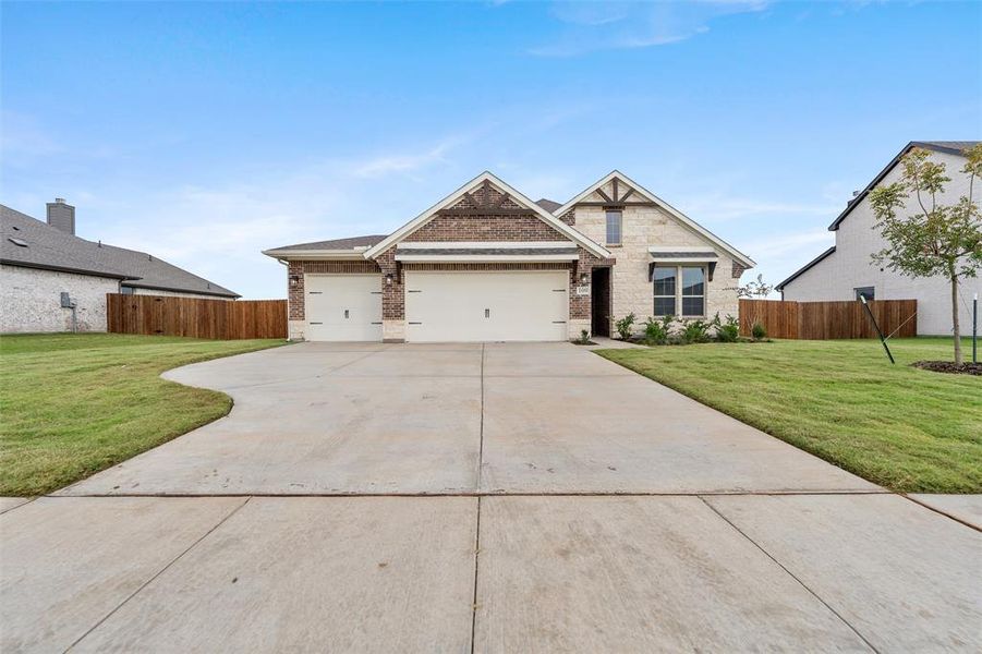 Craftsman-style house with brick siding, driveway, and a garage Craftsman-style house with brick siding, driveway, and a garage