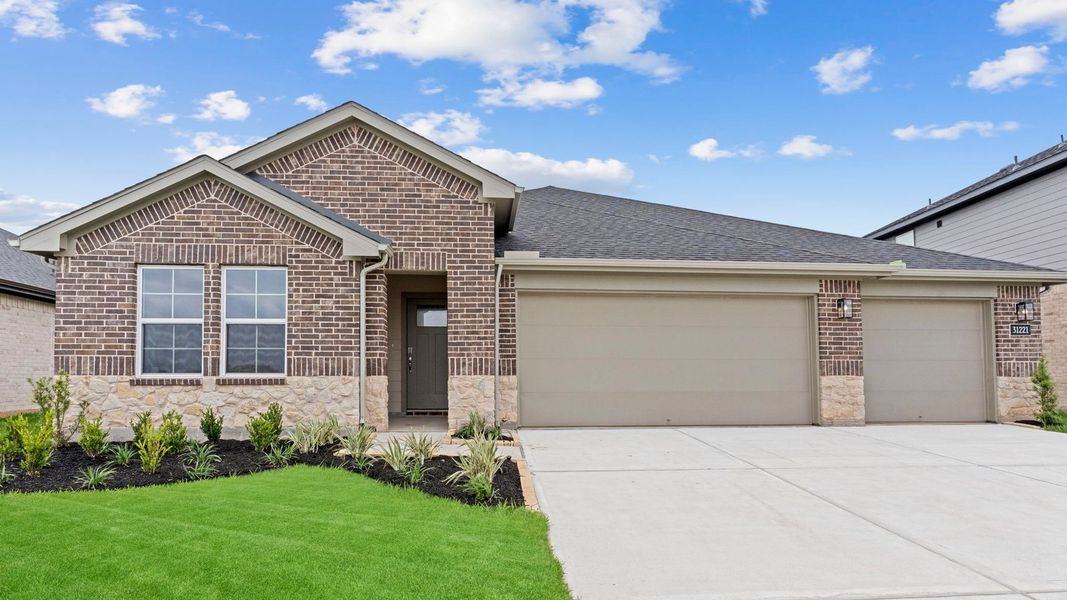 Front exterior of a new home in Tamarron, Fulshear, TX, highlighting curb appeal (Image 1). Front exterior of a new home in Tamarron, Fulshear, TX, highlighting curb appeal (Image 1).