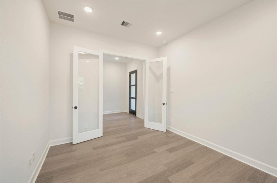 Glass french doors provide privacy at Study.
