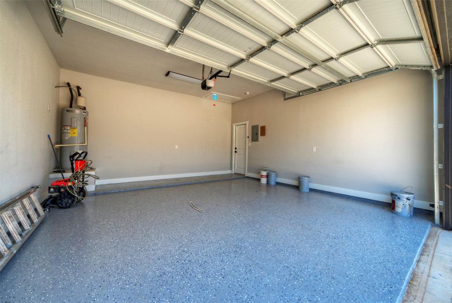 Finished walls and coated flooring elevate this functional vehicle storage area. Finished walls and coated flooring elevate this functional vehicle storage area.