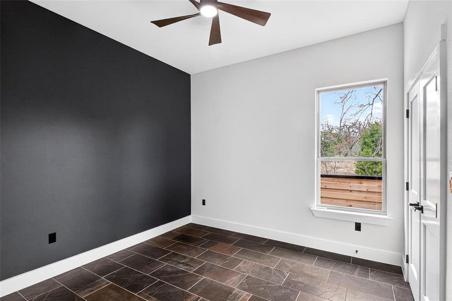 Empty room with a ceiling fan and baseboards