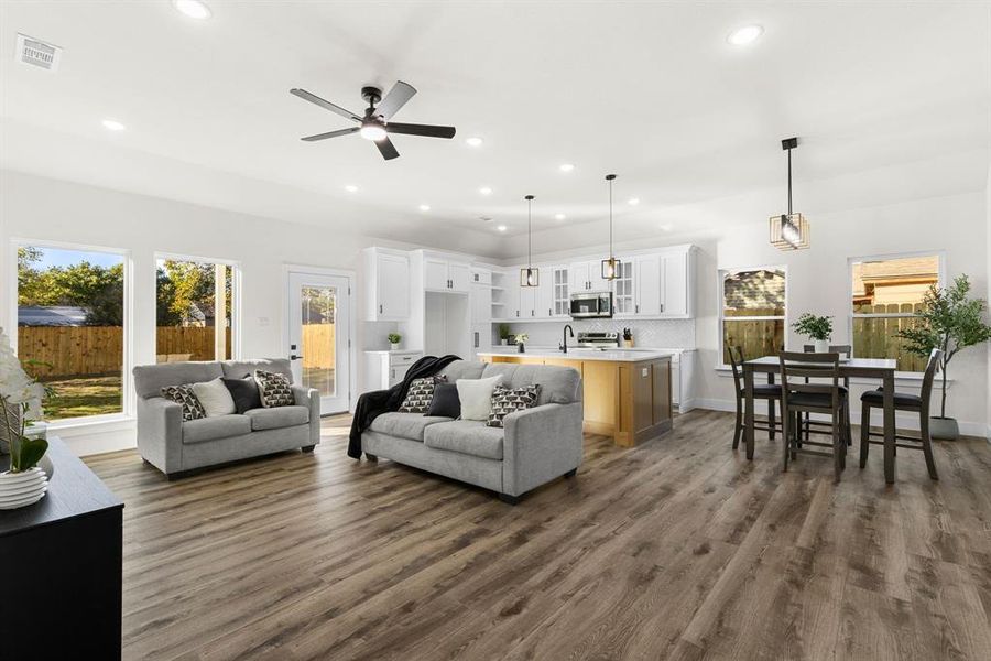 Living room with dark hardwood / wood-style floors and ceiling fan