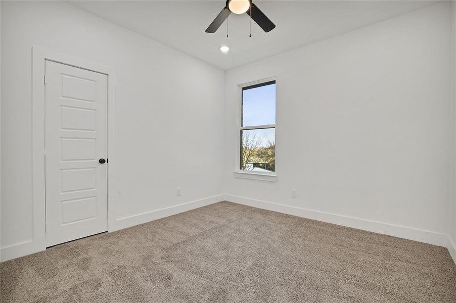 Bedroom with ceiling fan.