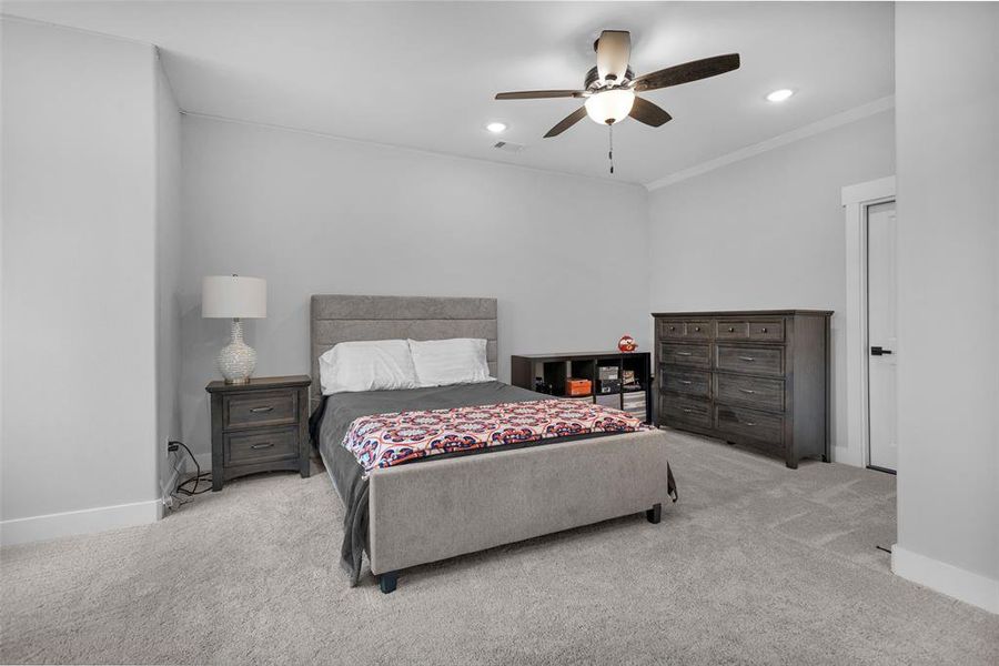 Spacious upstairs bedroom has walk-in closet and window for natural light.