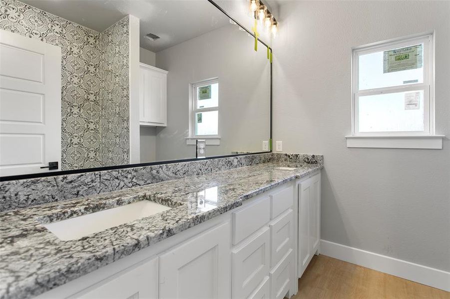 Bathroom with hardwood / wood-style floors and vanity