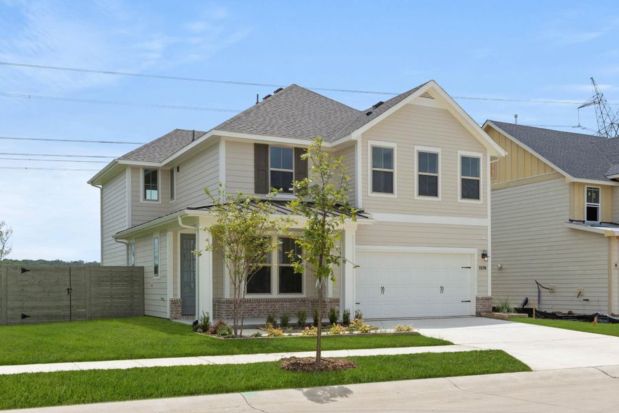 Front exterior of a new home in Cottage Collection at Harvest, Argyle, TX, highlighting curb appeal (Image 2).