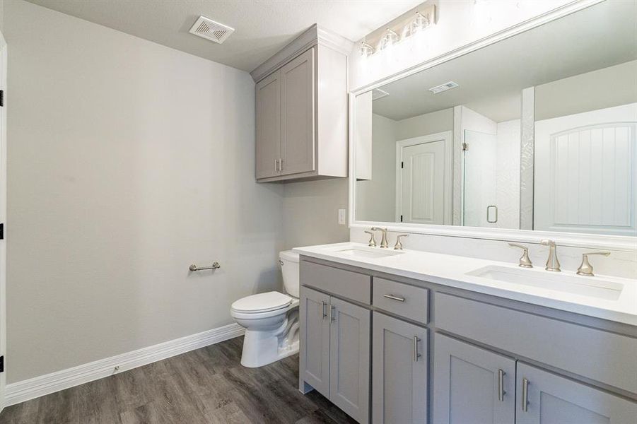 Double sinks, trimmed cabinets to ceiling