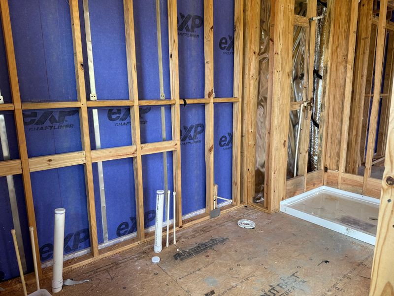 Primary en-suite bathroom with dual vanity and luxurious standing shower