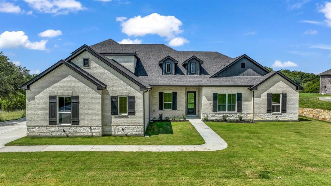 Front exterior of a new home in Woodland Lakes, Weatherford, TX, highlighting curb appeal (Image 2). Front exterior of a new home in Woodland Lakes, Weatherford, TX, highlighting curb appeal (Image 2).
