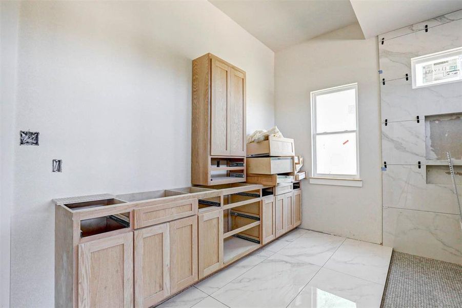 Kitchen featuring light brown cabinets