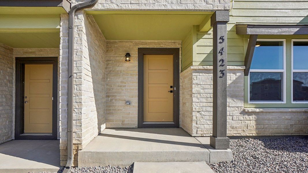 Exterior details and patio area of a home in Windler Townhomes, Aurora (Image 3).