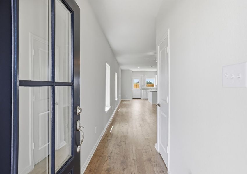 Entry hallway featuring wood-look flooring and a glass front door.
