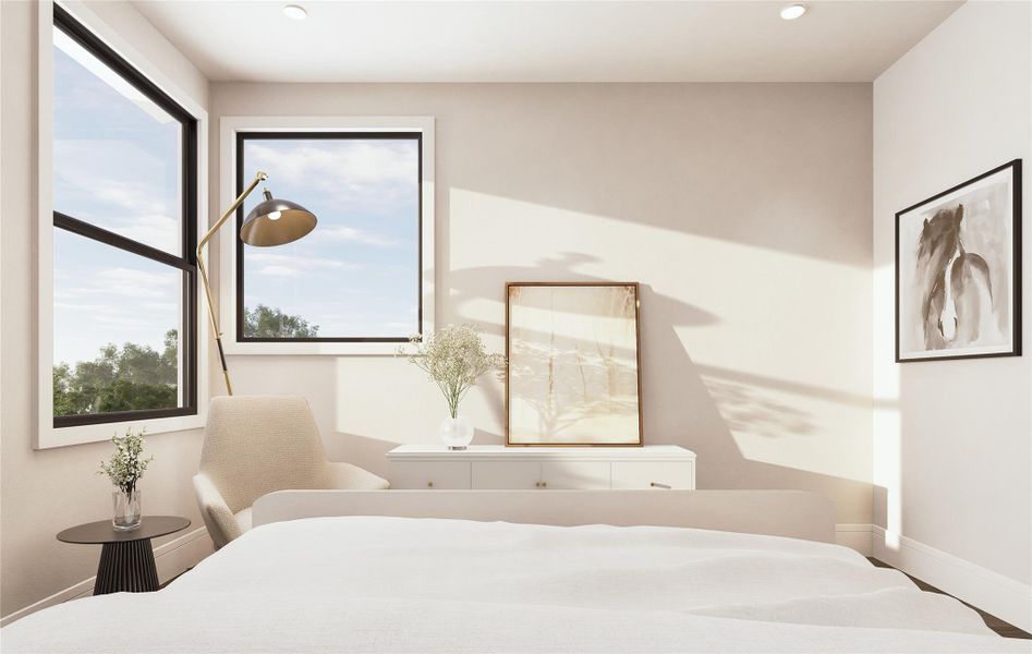 Natural light pours into this corner of the bedroom through dual windows, showcasing the simplicity of the space. A cozy chair and low-profile dresser suggest an intimate reading nook, while soft shadows and organic textures help shape an atmosphere designed for peace and quiet.